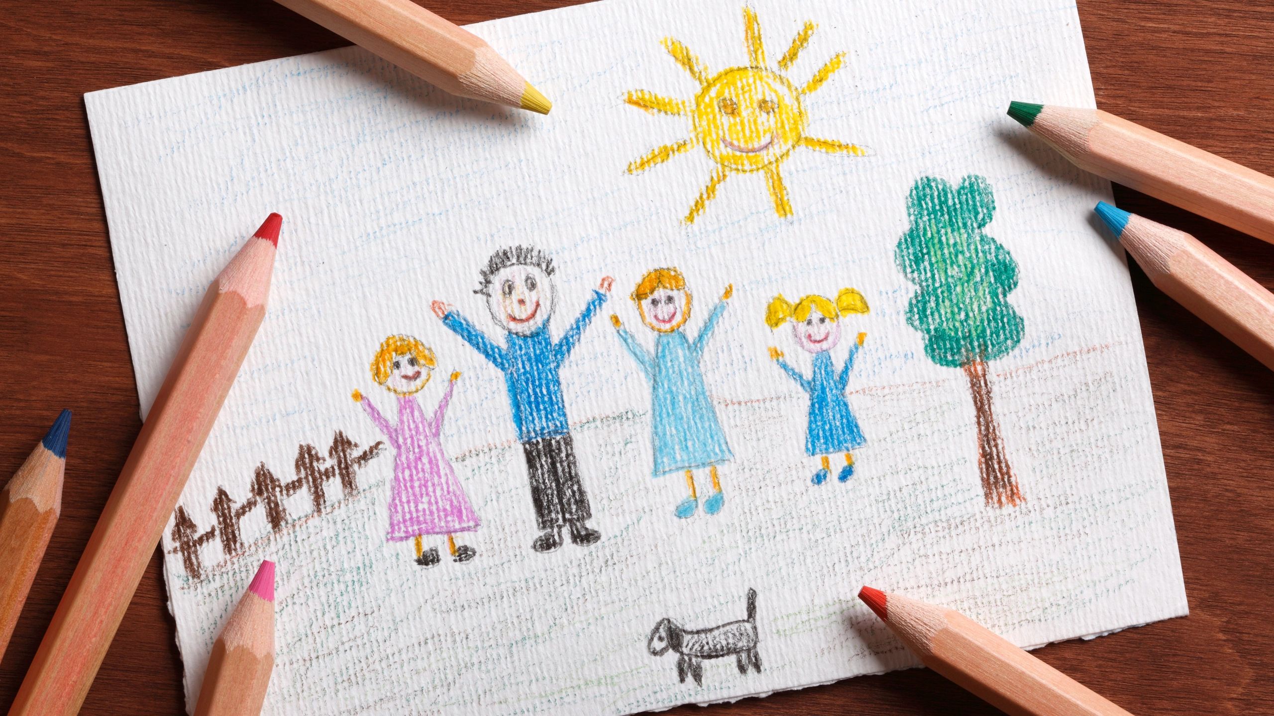 Child's drawing of a happy family with colorful pencils